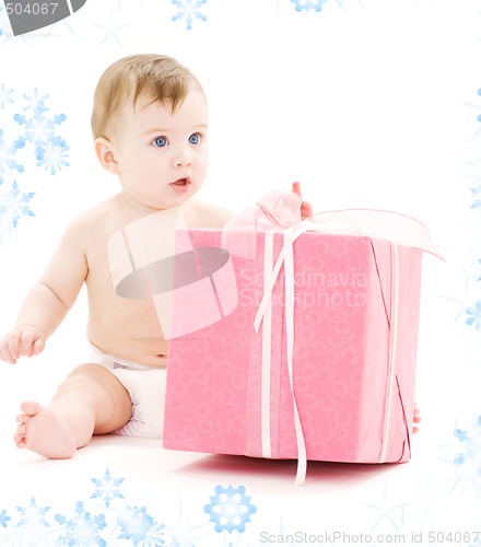 Image of baby boy in diaper with big gift box