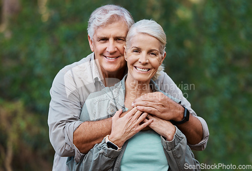 Image of Love, portrait and elderly couple hug in a forest for hiking, relax and walking in nature on blurred background. Face, embrace and happy senior man with woman on retirement vacation in the woods