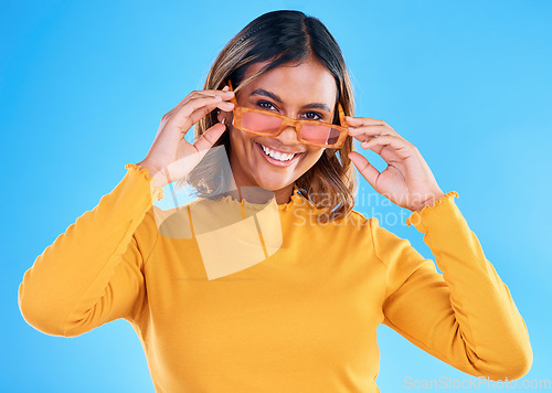 Image of Fashion, happy portrait or woman smiling with glasses, designer brand style or casual summer outfit. Gen z aesthetic, trendy sunglasses accessory or female face model on blue background studio