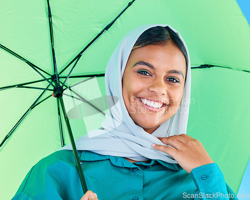 Image of Fashion portrait, Muslim and happy woman with umbrella, designer brand clothes or casual outfit style. Trendy gen z winter aesthetic, beauty smile and face of Arabic Islamic female in studio