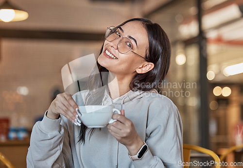 Image of Coffee shop, relax and portrait of woman with smile in restaurant for hot beverage, cappuccino and latte. Happy, cafe and face of girl sitting by table for tea break, relaxation and happiness weekend