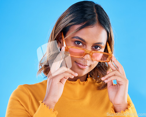 Image of Fashion, portrait and studio woman with sunglasses, designer brand style or casual summer outfit. Young gen z aesthetic, trendy glasses accessory and face of stylish female model on blue background