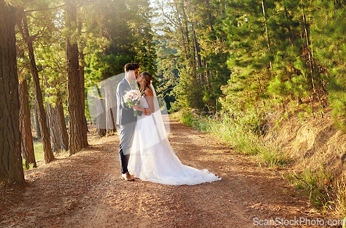 Image of Wedding, married and couple kiss in forest, garden and nature for celebration of love, care and commitment. Bride, groom and kissing in park for romance, bridal event and celebrate marriage ceremony