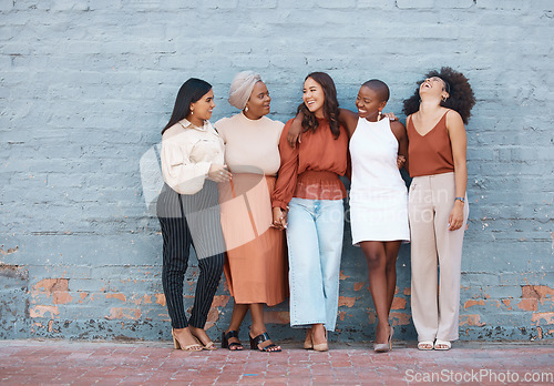 Image of Laughing, diversity and a team of business black women outdoor on a blue brick wall for conversation. Talking, joking or bonding with a female employee and colleague group taking a break outside