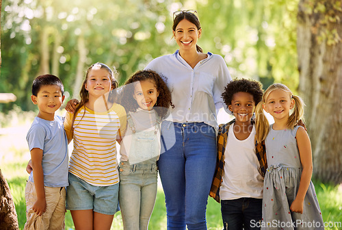 Image of Portrait, teacher smile and children outdoor in nature for holiday, vacation or learning. Education, happiness and group diversity of students with woman at summer park or garden having fun together.