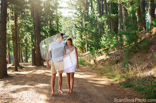 Image of Couple take a walk in forest, nature and travel, relax together with hug outdoor, love with care and bonding. Summer, holiday with man and woman strolling in countryside with relationship and trust