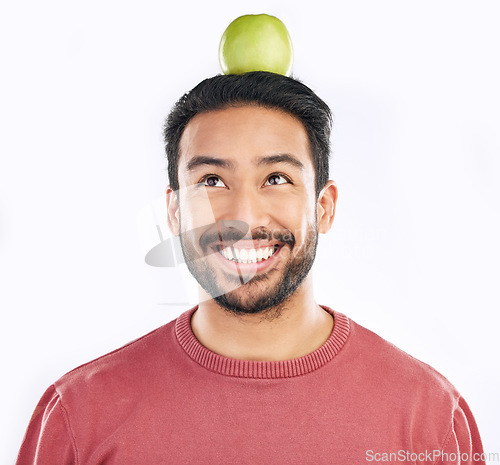 Image of Smile, apple and man in studio for diet, nutrition and balance with healthy breakfast on white background. Fruit, weight loss and asian guy nutritionist with organic, clean and fiber detox isolated