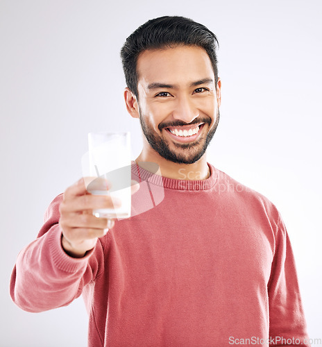 Image of Milk, man and smile portrait with happiness in studio with calcium, healthy and nutrition drink. Isolated, white background and model feeling happy from weight loss, wellness and detox diet smoothie