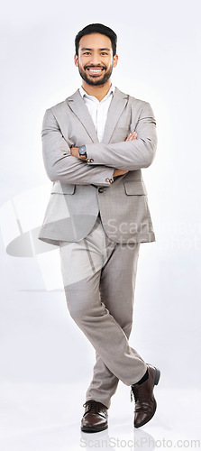 Image of Portrait, professional and a business man on a gray background, standing arms crossed in studio. Corporate, smile and trust with a happy male employee looking confident in the success of his company