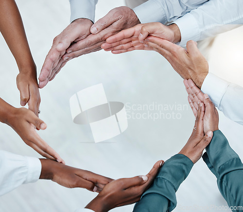 Image of Teamwork, collaboration and hands of business people in circle for motivation, support and community in office. Diversity, success and top view of men and women palms for goals, trust and solidarity