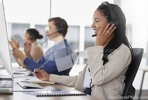 Image of Woman, call center and writing notes, smile in office and working on customer service in workplace. Telemarketing, talking and happiness of person, female sales agent or consultant consulting online.
