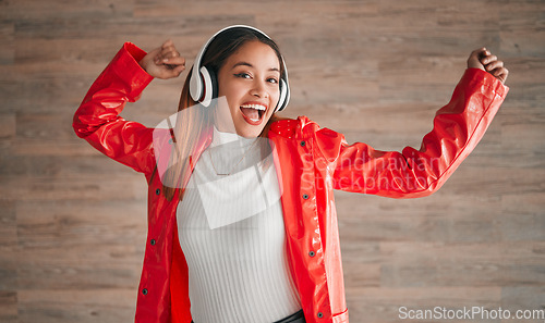 Image of Woman, singing and dancing with music headphones isolated on a wood background. Happiness, dance and portrait of female, person or singer listening, streaming and enjoying audio, radio or podcast.