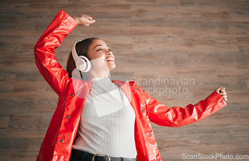 Image of Woman, happiness and dancing with music headphones isolated on a wood background. Freedom, dance and female or person listening, streaming or enjoying audio, radio song or podcast, sound and smile.