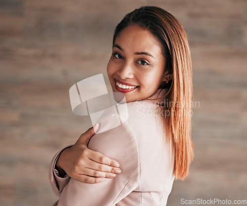 Image of Happy, beautiful and portrait of a woman on a wall at work with confidence, happiness and pride. Smile, content and executive employee working in corporate, professional business and management