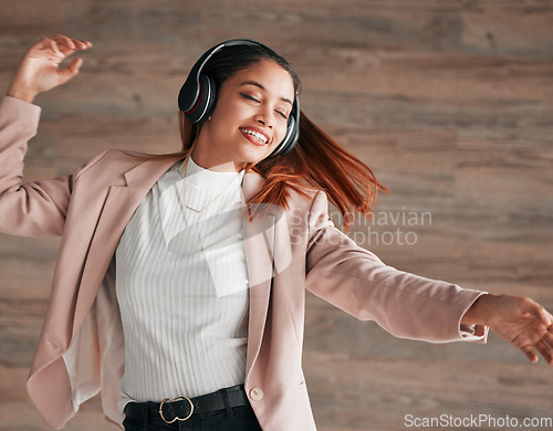 Image of Dancing, excited and woman streaming to music with happiness or listening to audio online using headphones. Radio, wellness and happy female person dance isolated in a wooden wall background