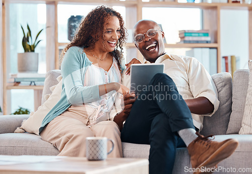 Image of Mature couple, tablet and sofa for laugh in living room with bond, love or video on app for memory. Black man, woman and mobile touchscreen for funny movie on web in house on lounge couch to relax