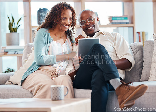 Image of Mature couple, tablet and sofa with smile in living room for bond, love and video on app for memory. Black man, woman and mobile touchscreen to watch movie on web, house and lounge couch to relax