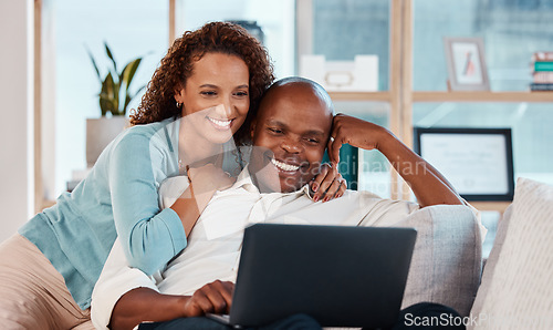 Image of Laptop, relax and a couple watching a video on a sofa in the living room of their home together for entertainment. Computer, movie or streaming with a man and woman enjoying a series while bonding