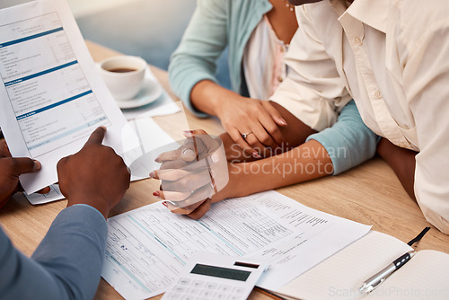 Image of Insurance, contract and a couple with an advisor for mortgage, loan or help with taxes. Holding hands, finance and a man and woman in a meeting with a lawyer for a legal strategy, plan and advice