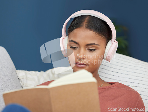 Image of Woman, music headphones and reading book on home sofa to relax, study and for peace in living room. Face of young female student on couch to read for knowledge, education and language on couch