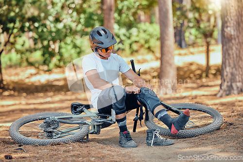 Image of Man, bicycle and knee pad for protection with cycling, dirt or nature in summer in extreme sport preparation. Mountain bike, cyclist or safety for exercise, workout or training for triathlon in woods