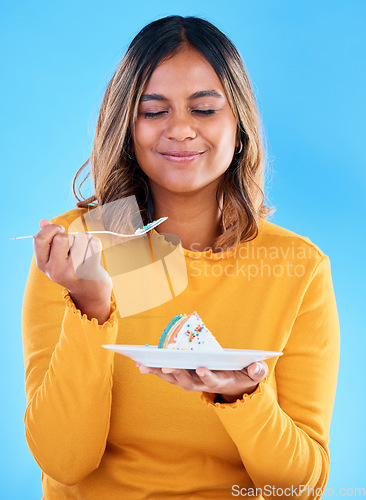 Image of Woman, fork and cake in studio for dessert, satisfied or eyes closed for happiness by blue background. Indian model, girl and happy for eating sweets, snack and test flavor for food, meal and diet