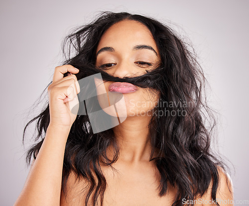 Image of Beauty, salon and woman smell hair, aesthetic and cosmetics on a grey studio background. Female, moustache and lady with facial expression, silly and goofy with treatment, smelling clean and wellness