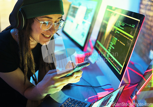 Image of Woman, phone texting and computer programmer in home for streaming radio or podcast in neon. Hacker, music headphones or happy female coder with mobile for sound, audio or typing on dark web at night