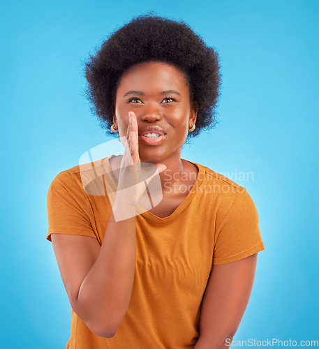 Image of Black woman, privacy and gossip in studio, sharing exciting news or confidential drama on blue background. Deal announcement, whisper and happy African girl with afro, discussion isolated in secret.