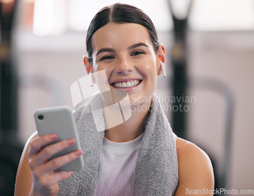 Image of Gym, relax and portrait of happy woman with phone and headphones on workout break checking social media. Exercise, rest and person with smartphone for fitness app, music or networking for motivation.
