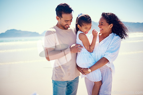 Image of Happy family, beach smile and playing of a mother, father and girl together by the ocean. Nature, sea and love of a mom, dad and child in Philippines on vacation with parents tickle on travel holiday