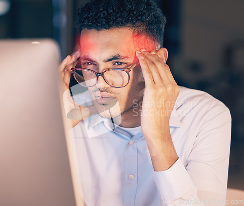 Image of Man, headache and computer in stress, burnout or suffering pain at night by office desk. Businessman employee rubbing head or touching painful area by desktop PC feeling overworked at workplace