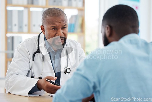 Image of Doctor, serious black man and patient consultation in hospital for talking, checkup or results. Healthcare, medical professional and African person consulting physician for advice or cancer diagnosis