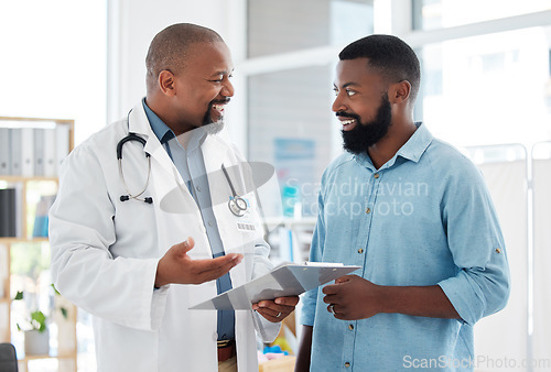 Image of Doctor, black man and patient with clipboard in consultation, talking or health results in hospital. Healthcare, paperwork and happy medical professional with mature person with checklist in clinic.
