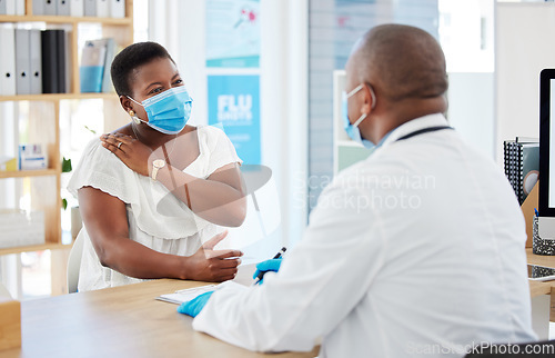 Image of Doctor, covid and patient with shoulder pain in hospital, fibromyalgia or inflammation. Face mask, healthcare professional and black woman with injury, arthritis or painful tendinitis in consultation