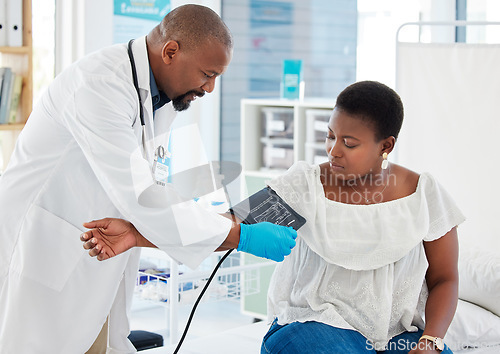 Image of Helping, healthcare and a doctor with a black woman for hypertension, health check and service. Help, medical and a gp consulting with a patient for blood pressure exam, cardiology or monitor