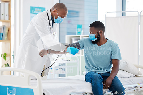 Image of Doctor, covid and blood pressure with black man for heart health, test and examination. Face mask, hypertension and patient, medical professional and sphygmomanometer for consultation in clinic