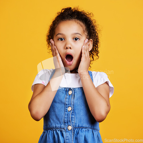 Image of Portrait, wow and girl surprise, shock and kid amazed against a studio back ground. Face, young person and female child with facial expression, emoji and touching cheeks with news and announcement