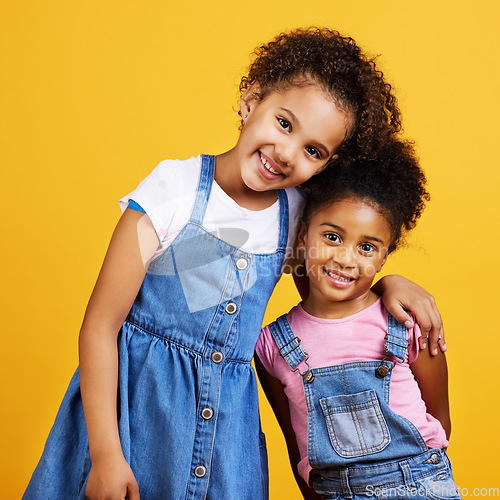 Image of Children, smile portrait and happy sisters in studio with love, care and support of family on yellow background. Cute young girl kids or friends together for happiness, hug or trust with mockup space