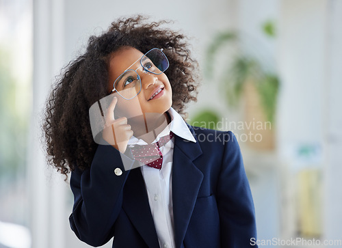 Image of Thinking, smile and a girl dressed as an employee with a plan, idea or strategy in an office. Happy, cute and a little child playing pretend in business with a solution, thoughtful and ideas