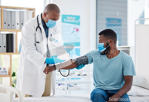 Image of Doctor, covid and blood pressure with black man patient for heart health, test or examination. Healthcare, hypertension and person, medical professional or sphygmomanometer for consultation in clinic