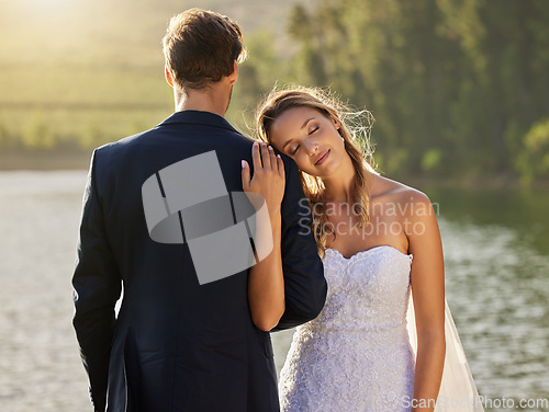 Image of Affection, love and a couple at a lake wedding with comfort, content and celebration of marriage. Calm, peace and a man and woman embracing after a relationship commitment ceremony in nature