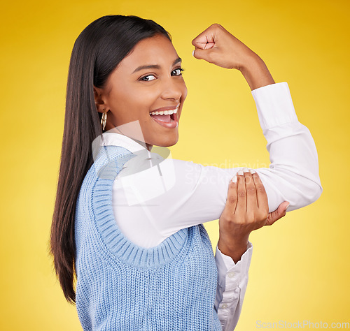 Image of Arm, flex and portrait of woman in studio for winner, success and empowerment. Gender equality, satisfaction and champion with female on yellow background for pride, muscle strength and achievement