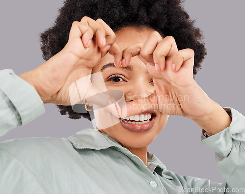 Image of Heart, eye and hands with portrait of black woman in studio for happiness, support and emoji. Peace, focus and shape with female holding symbol on gray background for hope, kindness and trust