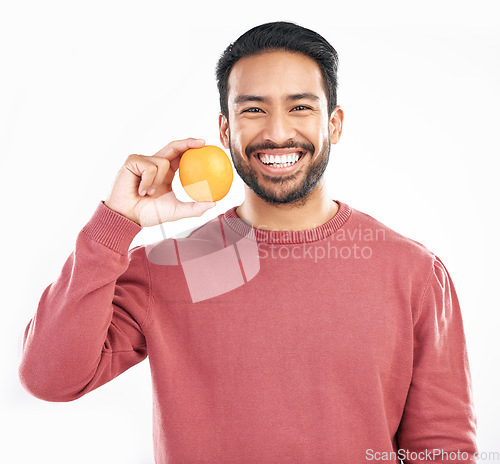 Image of Orange fruit, happy man and portrait in studio, white background and wellness of healthy food. Smile, male model and vitamin c citrus for nutrition, organic juice and detox diet of raw ingredients