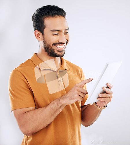 Image of Man, tablet and smile in studio on social media, reading ebook and online website on white background. Happy male model, digital technology and connection for networking, search internet and download