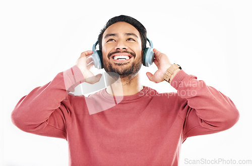 Image of Headphones, smile and music, happy man in studio isolated on white background streaming radio and happiness. Podcast subscription, technology and song, Indian guy listening to audio online to relax.