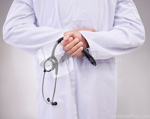 Image of Medical, stethoscope and back with hands of doctor in studio for healthcare, cardiology and checkup. Medicine, support and expert with man on gray background for advice, heartbeat and consulting