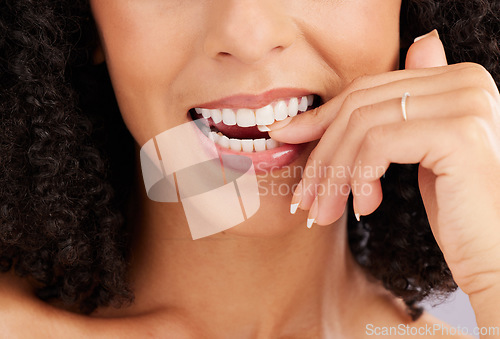 Image of Woman, mouth and teeth closeup, flirt and bite finger with hand and manicure with beauty, dental and whitening. Makeup, natural cosmetics and flirtatious female, skincare and glow with orthodontics