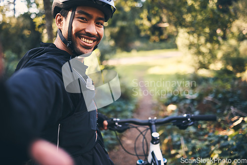 Image of Selfie, cycling and smile with man in nature for social media, training and workout. Happiness, internet and exercise with portrait of cyclist on bike in forest park for adventure, cardio and picture